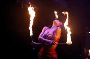 LIMBO's sword swallower and vintage beauty, Heather Holliday, eats fire.